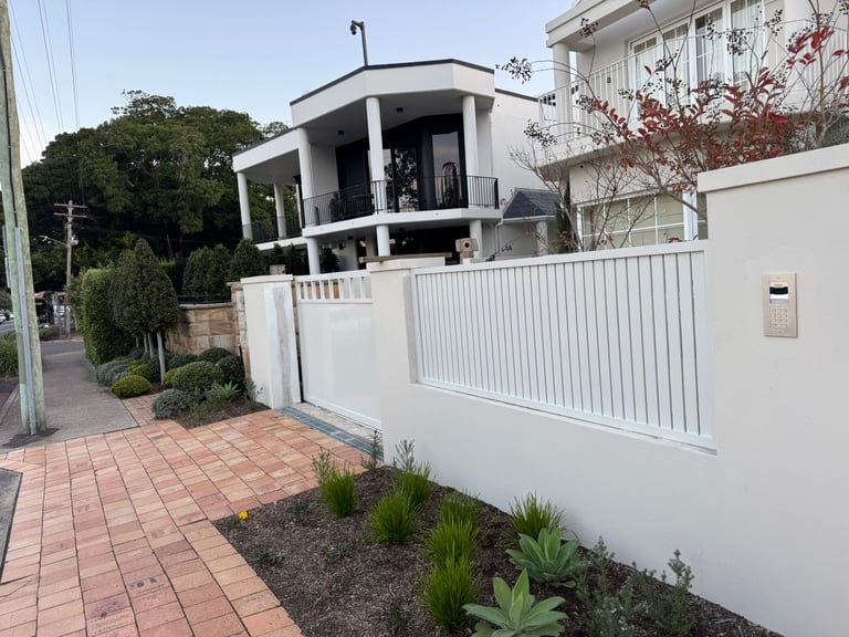 Landscaping project with modern house, metal fence gate and brick driveway, Warwick Farm